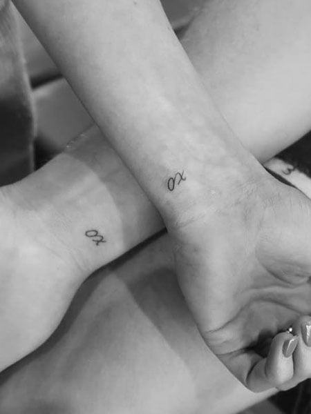 Matching hand poked heart tattoo for sisters