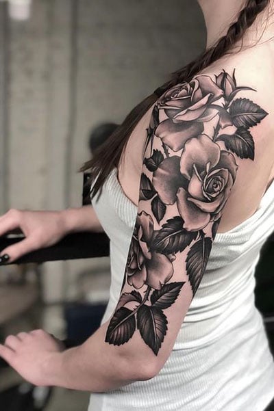 Blackworkillustrative rose tattoo on the upper back