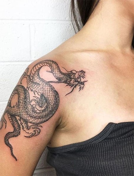 Minimalist dragon tattoo on the inner arm