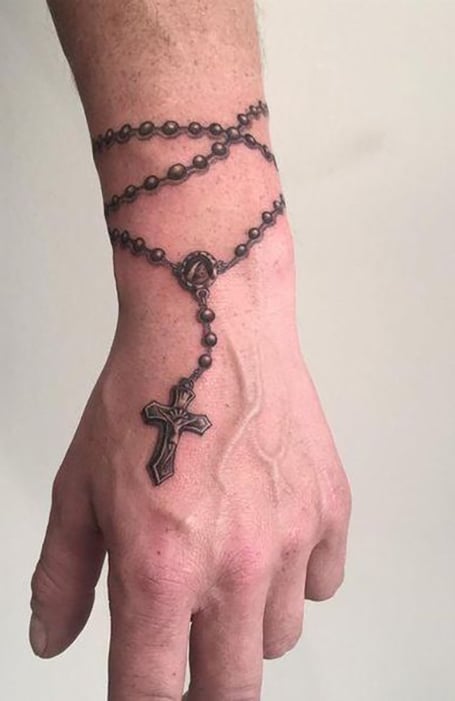 31 Rosary Beads Tattoos With Symbolism and Meanings  TattoosWin  Rosary  tattoo on hand Pretty hand tattoos Hand tattoos