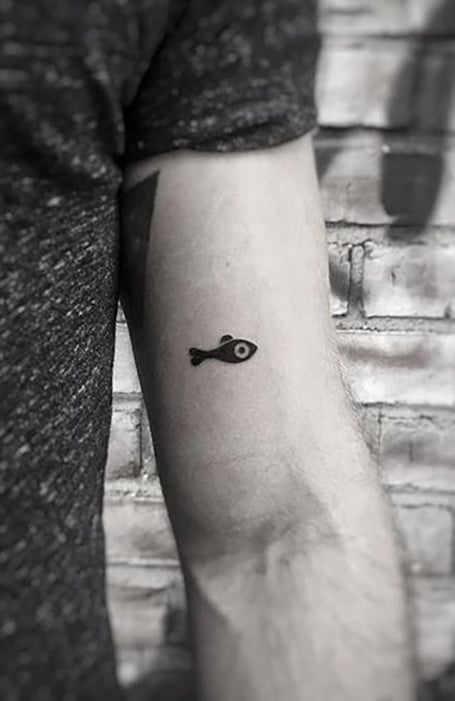 Tiny koi fish tattoos on the inner wrist