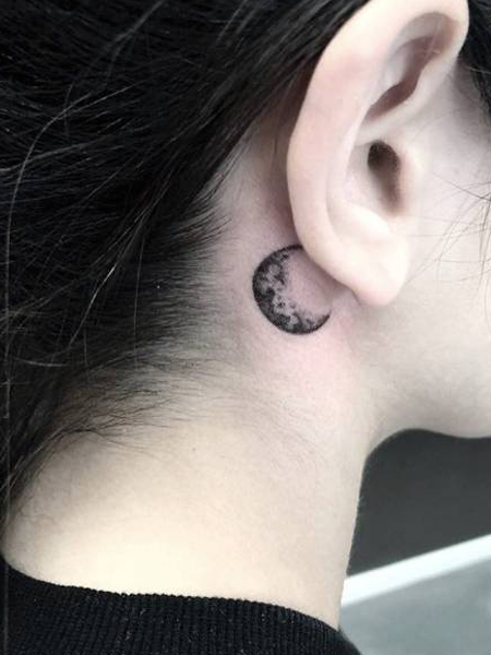 Minimalistic crescent moon tattoo done behind the ear