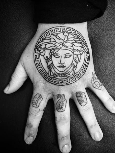 Angel wing with Versace logo tattoo Calgary 🇨🇦 2048980992 #goldsmith... |  TikTok