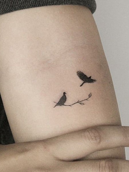 Tattoo uploaded by Benjamin  Small size flock of birds flying on underside  of wrist in black silhouettes  Tattoodo