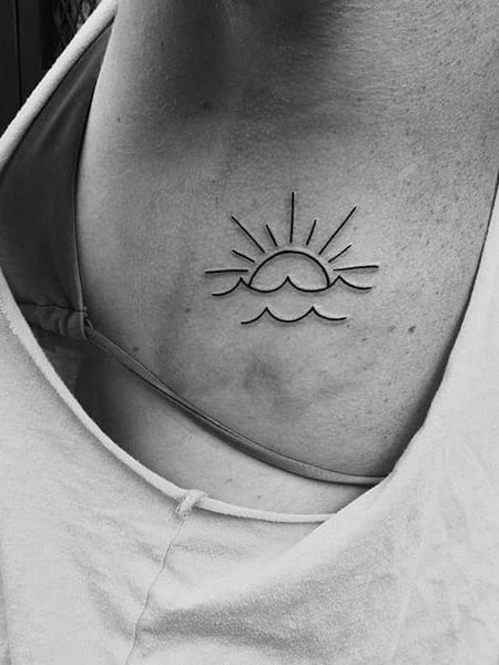 Minimalist sun and wave tattoo on the hip