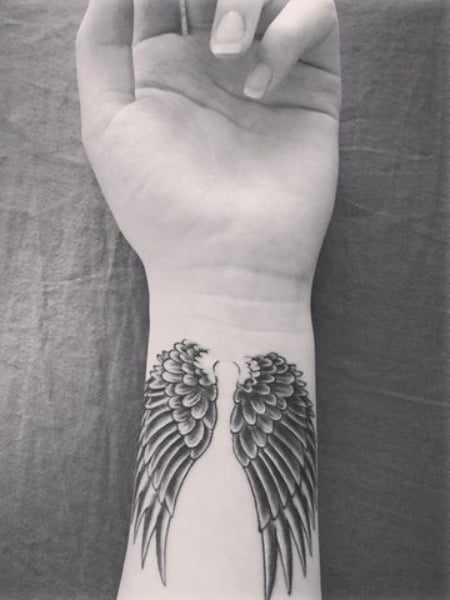 Angel wings tattoo  Wrist tattoos for guys Small tattoos for guys Small  forearm tattoos