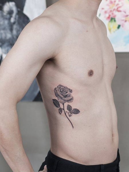 Single needle rose tattoo on the left side ribcage