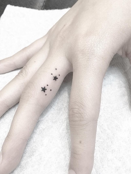 Minimalist hand poked north star tattoo on the finger