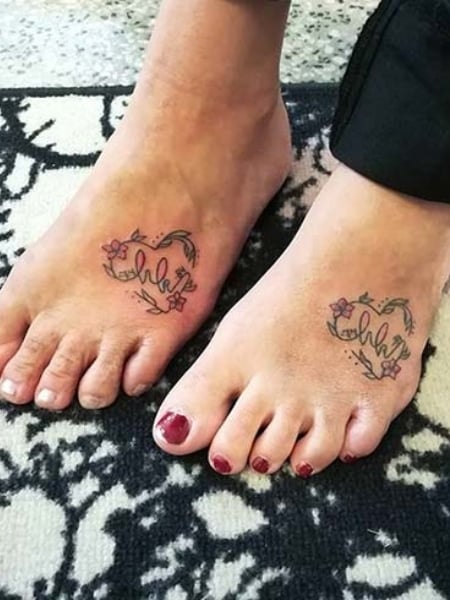 Foot tattoo cover up with plumeria flowers by Laura Jade TattooNOW