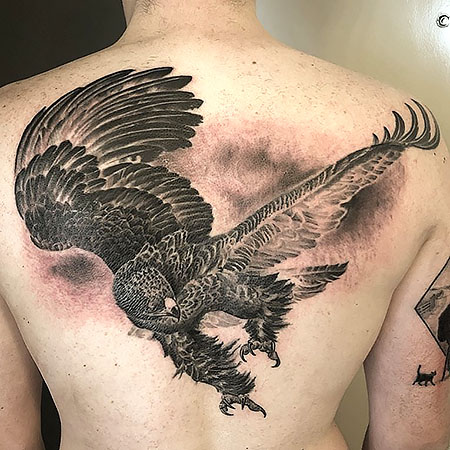 Large eagle tattoo located on the upper back