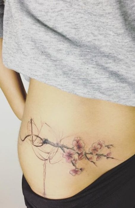 Beautiful floral tattoo on the left hip - Tattoogrid.net