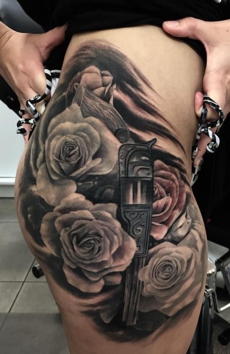 Detailed revolver hand gun  roses thigh tattoo  Golden Iron Tattoo  Studio DownTown Toronto