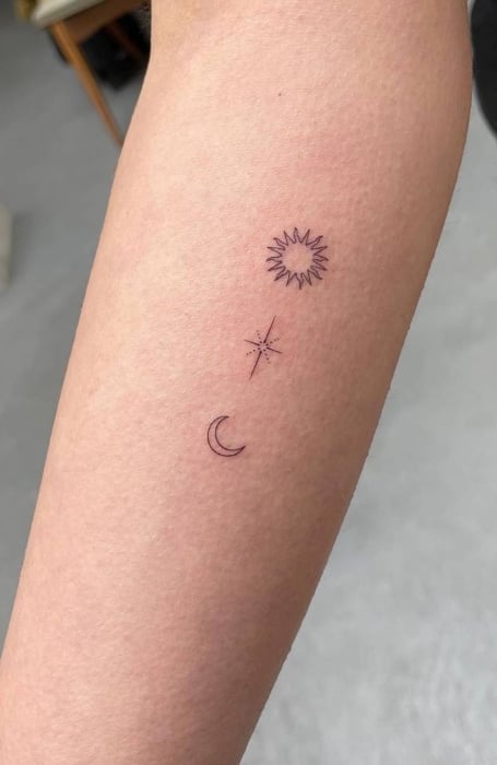Moon phases sun and hands tattoo on the upper back