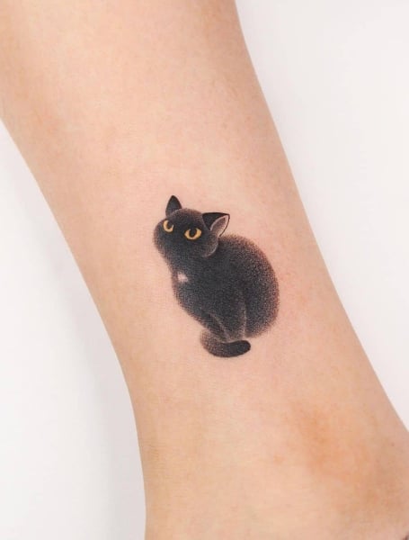 Black Ink Cheshire Cat Tattoo On Ankle