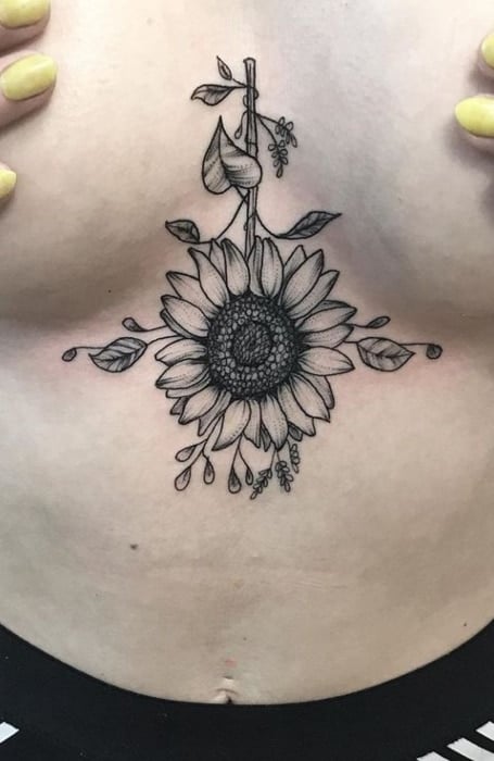 Black and grey sunflower tattoo done on the sternum